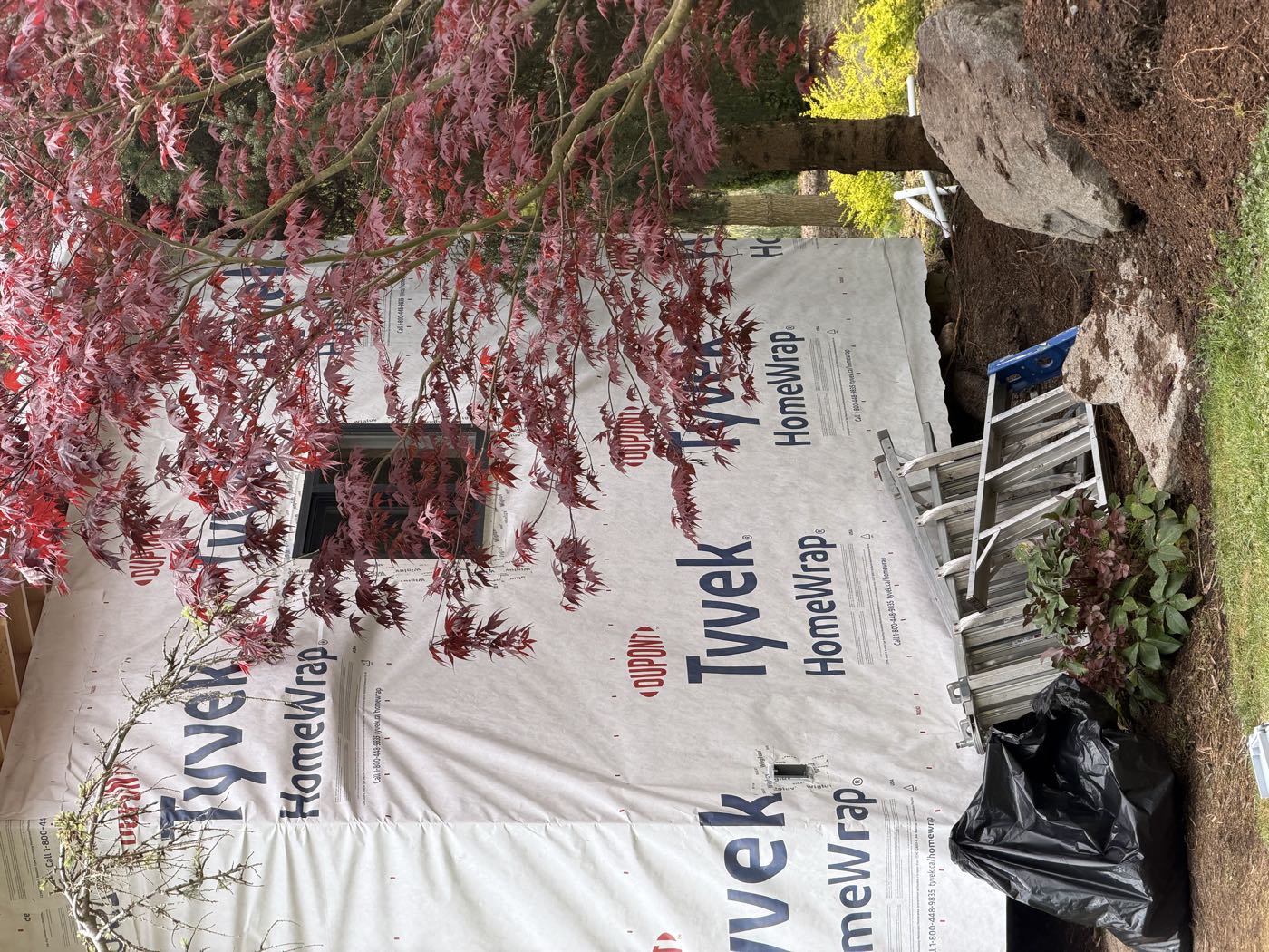 Close view of the weather-resistive barrier lapped shingle-fashion around a window rough opening.
